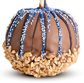 An apple coated in chocolate with blue chocolate stripes. The bottom has crushed peanuts.